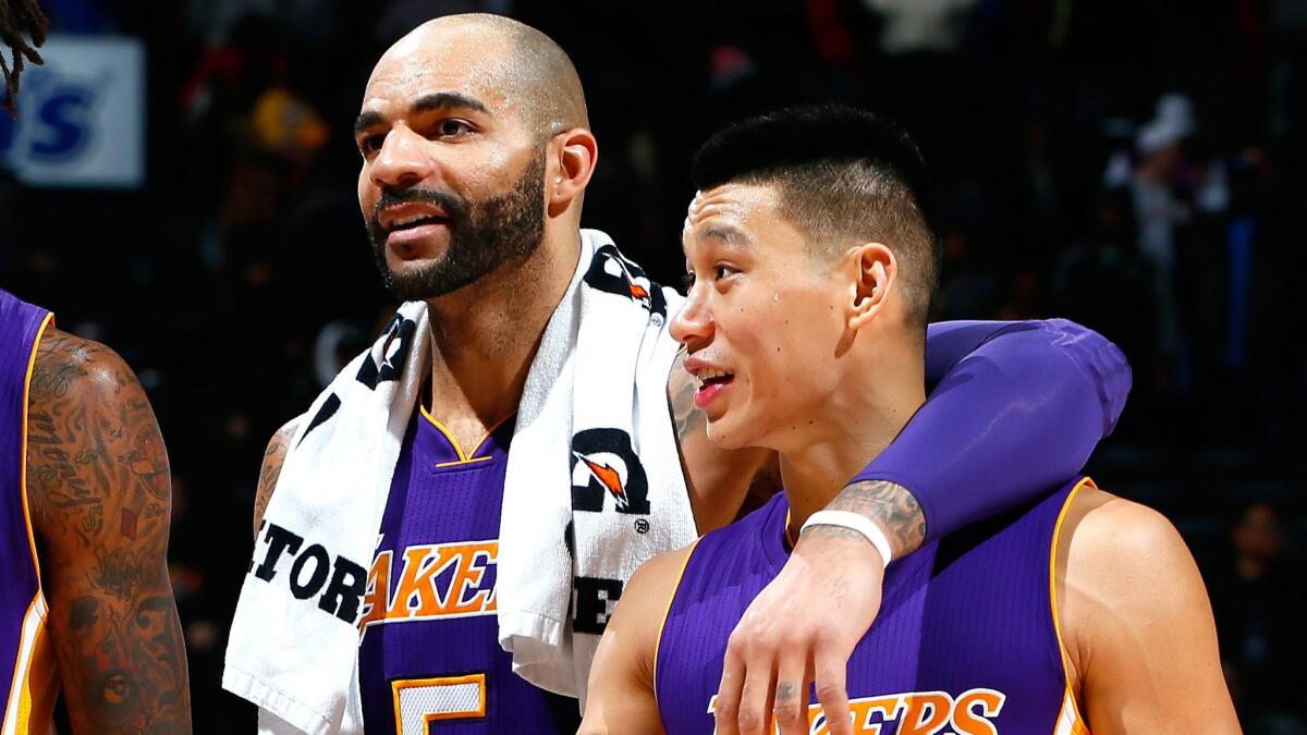 Lakers teammates Carlos Boozer, left, and Jeremy Lin celebrate the team's win over the Atlanta Hawks on Nov. 18.