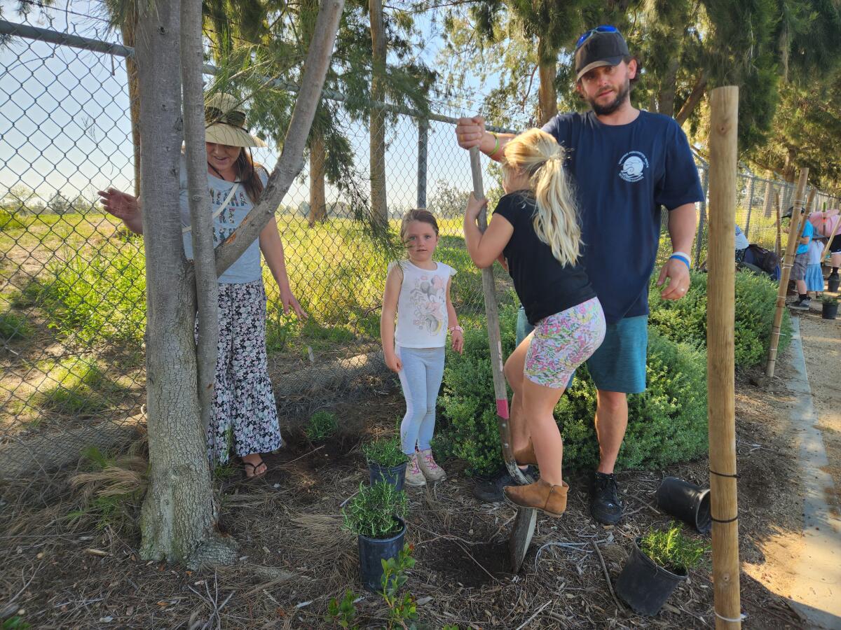 Afton Fieldson, daughters Jasmine and Azalea, and husband Tony in a Community Service Day project.