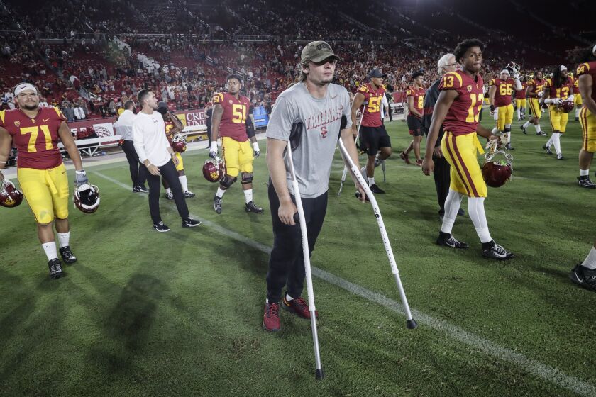 LOS ANGELES, CA, SATURDAY, AUGUST 31, 2019 - USC quaerterback JT Daniels hobbles on crutches after a 31-23 win over Fresno State at the Coliseum. (Robert Gauthier/Los Angeles Times)