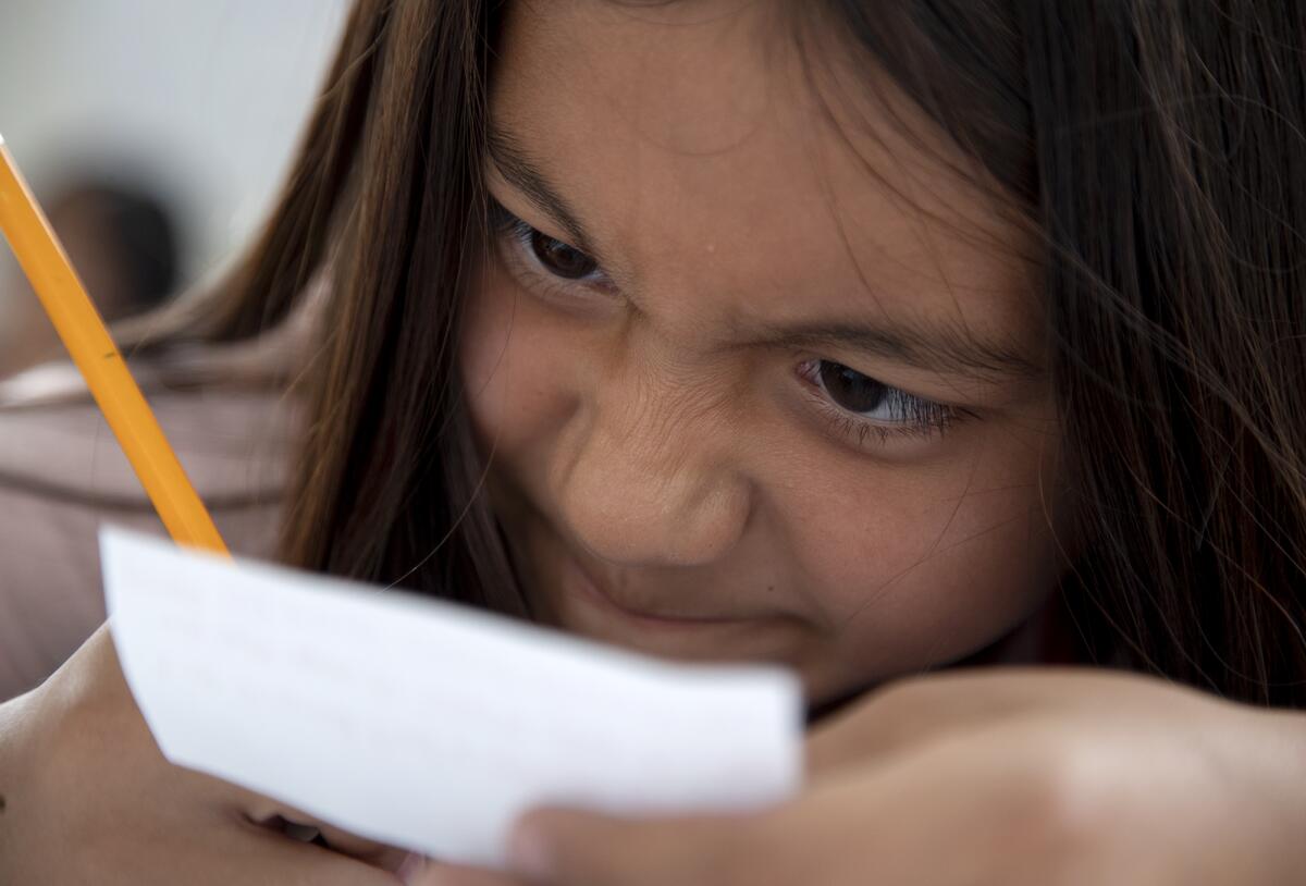 Jazlyn Ramirez, 9, concentrates on writing her proposal for an elevator pitch.