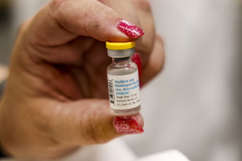 A nurse holds a vial containing the monkeypox vaccine at a vaccination clinic run by the Mecklenburg County Public Health Department in Charlotte, N.C., Saturday, Aug. 20, 2022. (AP Photo/Nell Redmond)