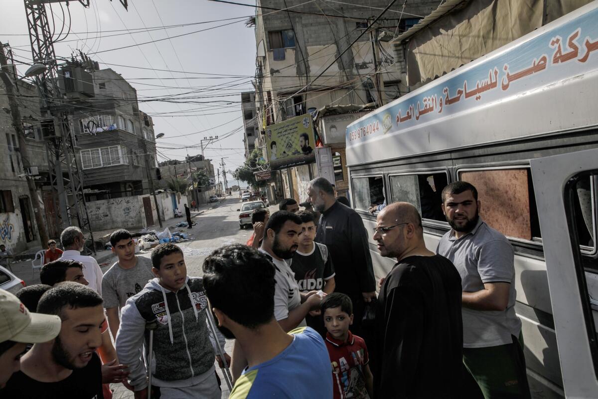 Palestinians wait to board busses that will transport them to the border separating Israel and Gaza for the first Friday of the holy month of Ramadan protest in Gaza City on May 18