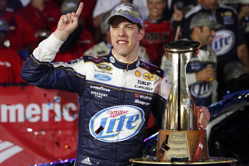 Brad Keselowski celebrates after winning Saturday's NASCAR Sprint Cup race at Charlotte Motor Speedway.