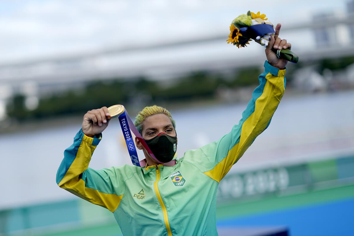 Ana Marcela Cunha of Brazil celebrates after winning the gold in women's marathon swimming.