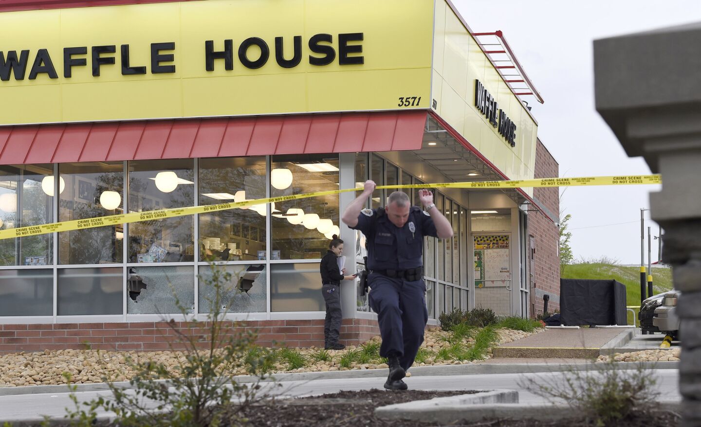 Law enforcement officials work the scene of a fatal shooting at a Waffle House in the Antioch neighborhood of Nashville on Sunday.