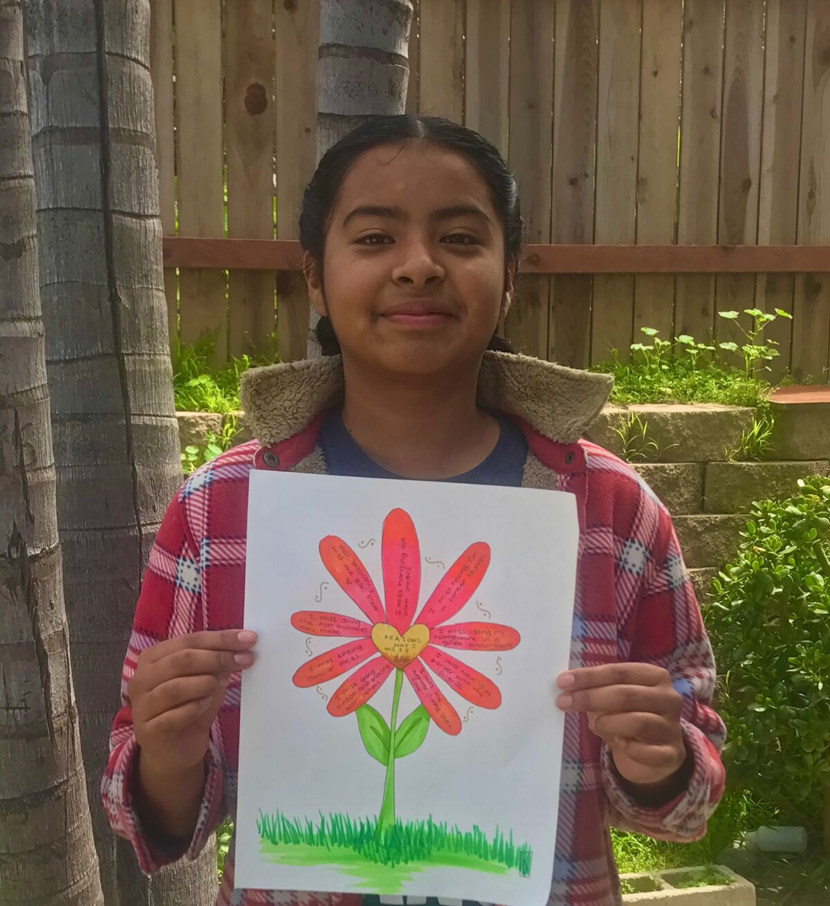 A Boys & Girls Club member with her drawing.