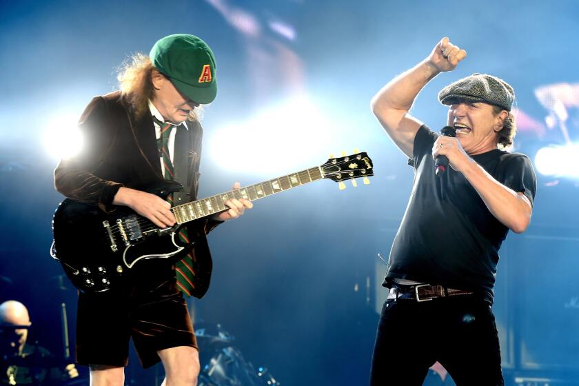 Angus Young, left, and Brian Johnson of AC/DC at Monday's Dodger Stadium concert in Los Angeles.