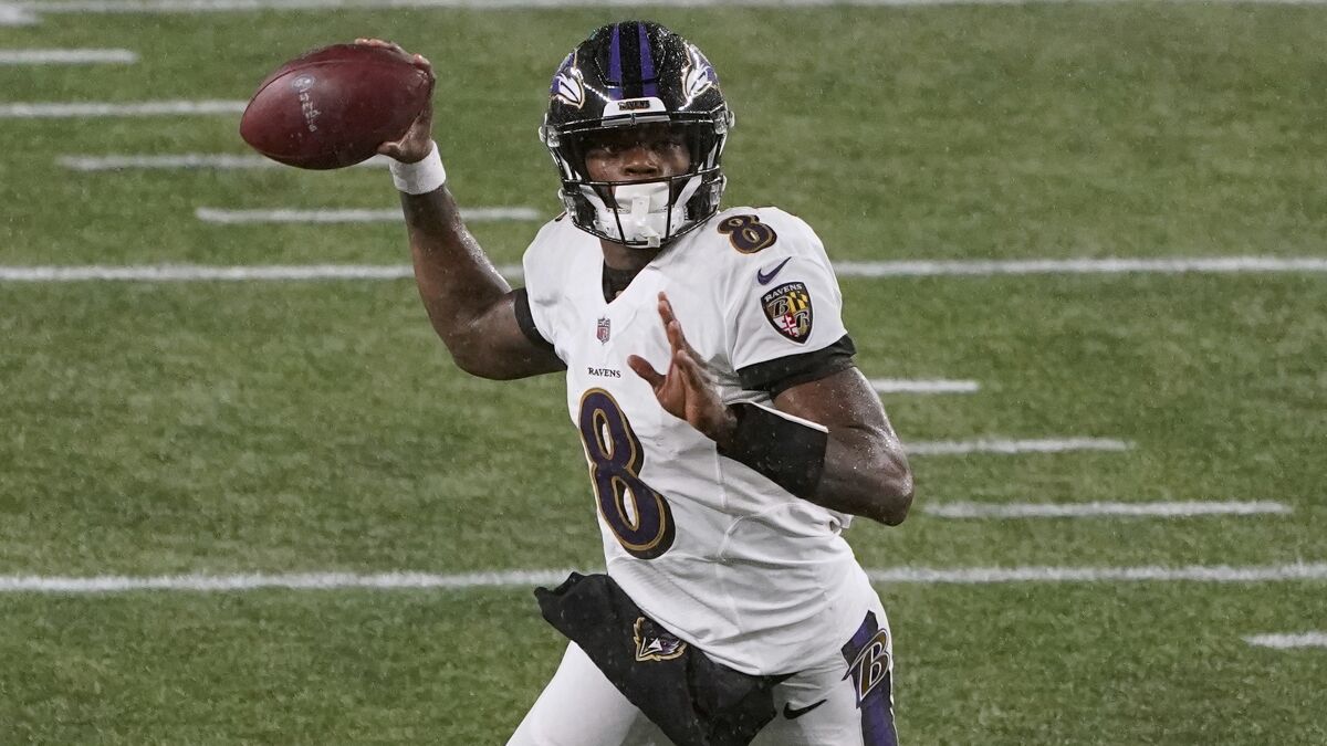 Baltimore Ravens quarterback Lamar Jackson passes the ball against the New England Patriots.