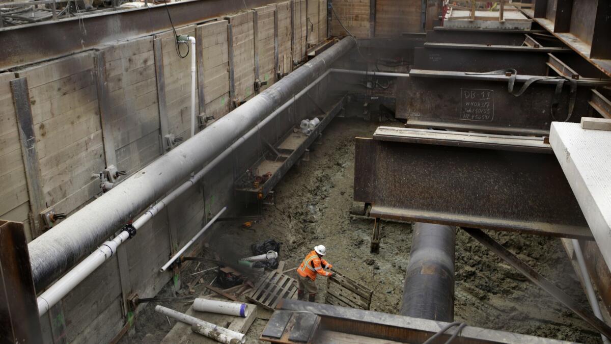 Crews work on the Metro Purple Line subway at La Brea and Wilshire in 2017. The $9-billion, nine-mile project will connect West Los Angeles to downtown by rail.