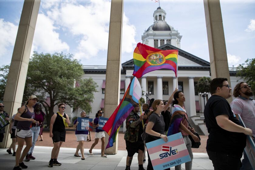 An estimated 200 people marched from Westcott Fountain to the Florida Capitol, Friday, March 31, 2023, in Tallahassee, Fla., to express their opposition to HB 1069, an expansion on the "Don't Say Gay" bill from last session. (Alicia Devine/Tallahassee Democrat via AP)