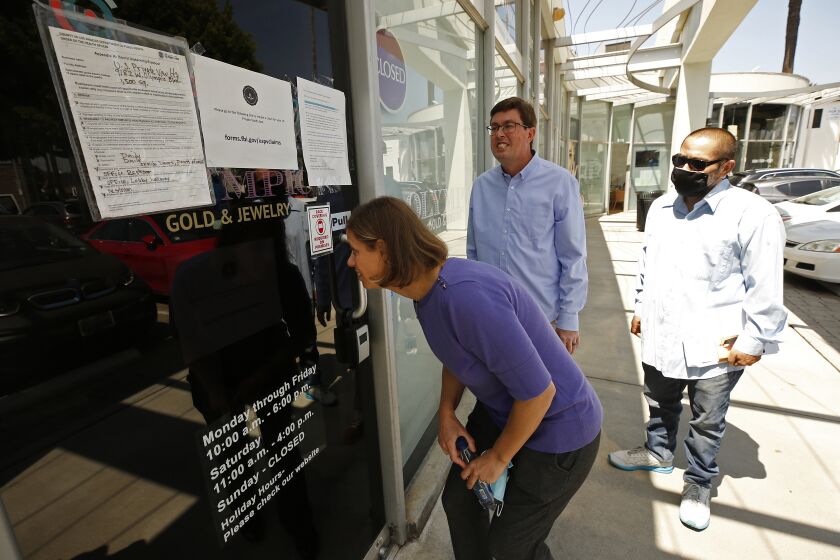 BEVERLY HILLS, CA - MAY 27: Plaintiffs Jennifer Snitko, husband Paul Snitko, and Joseph Ruiz, left to right, outside US Private Vaults in Beverly Hills where the three had rented safety deposit boxes. The three with their attorney Robert Frommer, senior attorney at the Institute for Justice, held a press conference to announce a new lawsuit demanding return of their belongings. The FBI is trying to confiscate $86 million in cash and millions more in jewelry and other valuables from 376 safety deposit boxes it seized in a raid. But box holders say it was an illegal search - that the warrant the FBI secured from a judge explicitly barred the government from searching the contents of their boxes. U.S. Private Vaults on Thursday, May 27, 2021 in Beverly Hills, CA. (Al Seib / Los Angeles Times).