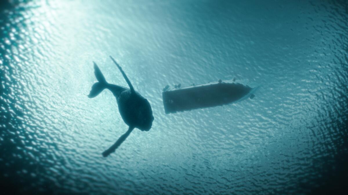 In a still from "The Swarm," the underside of a whale and a boat is seen in the ocean.