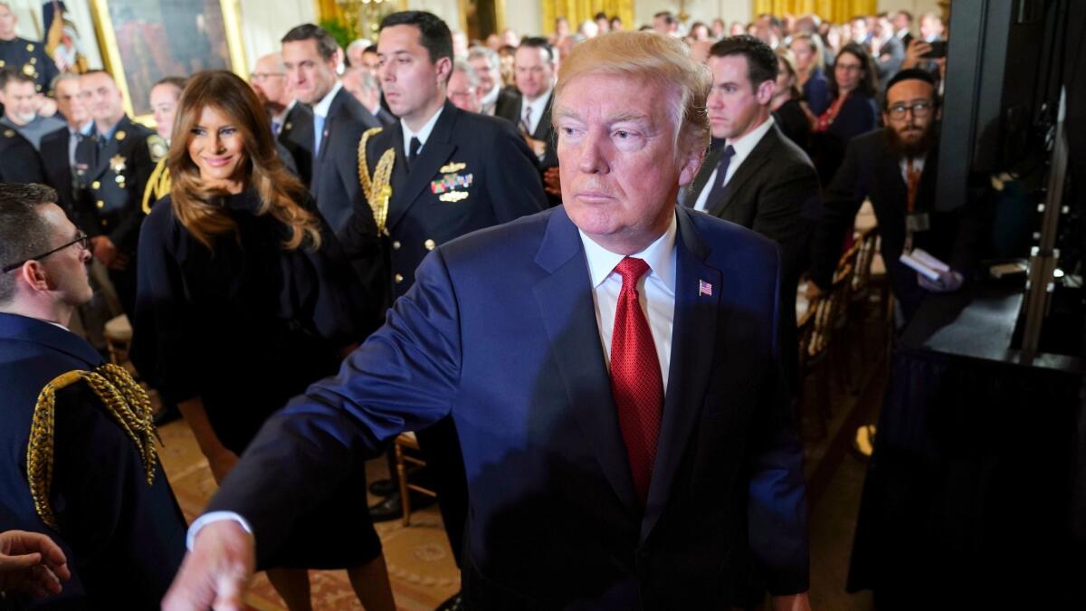 President Trump and First Lady Melania Trump leave the East Room of the White House in Washington after speaking on the opioid crisis on Oct. 26.