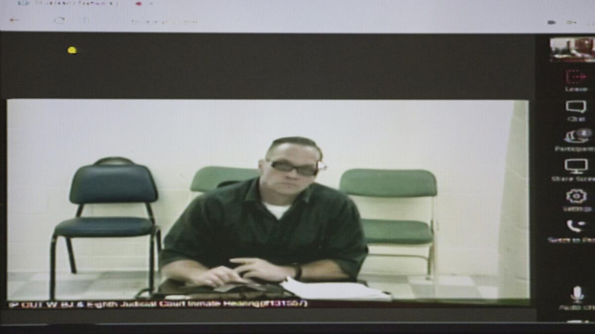Nevada death row inmate Scott Dozier appears at a court hearing via video in December.