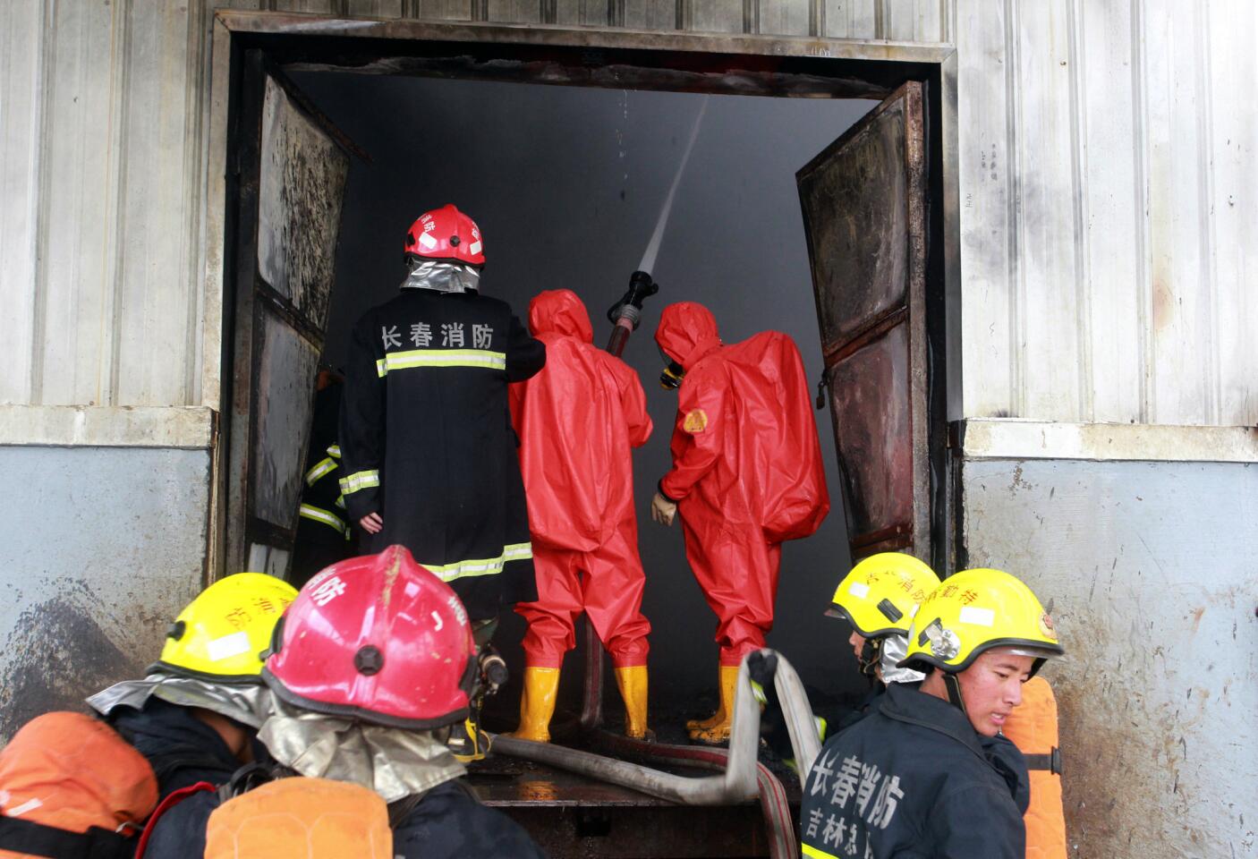Firefighters put out the blaze at a poultry plant that caught fire in northeast China. More than 100 people were killed in the blaze in Jilin province's Mishazi township.