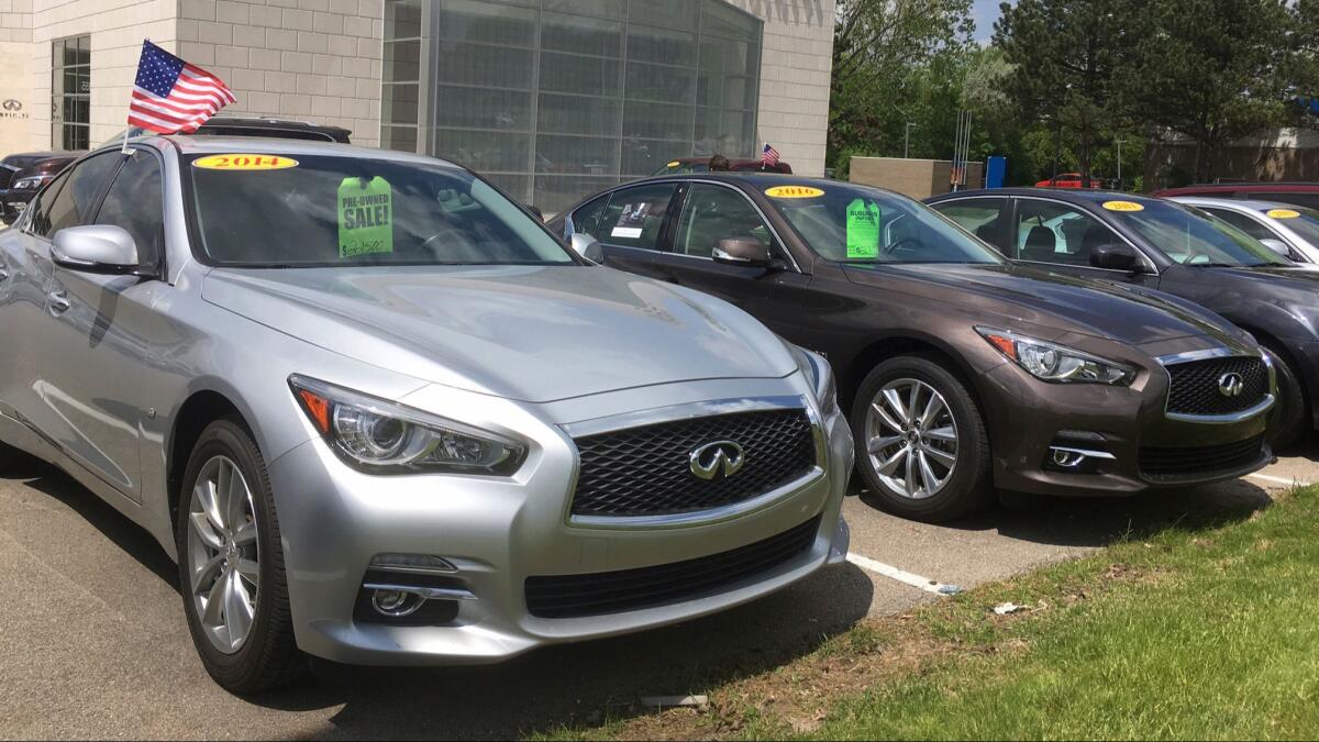 Used Infiniti Q50 luxury sedans await buyers at a dealership in the Detroit suburb of Novi, Mich.