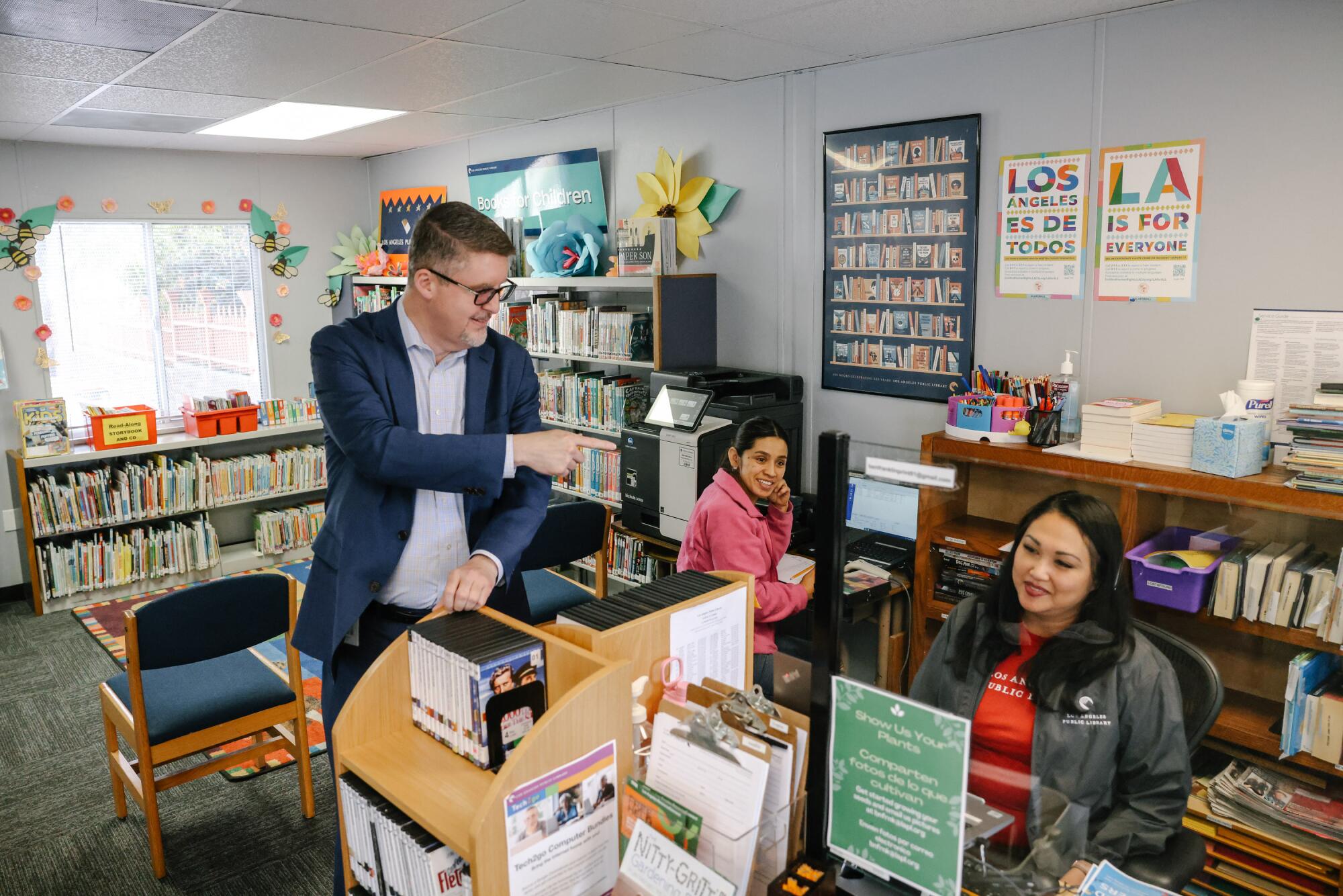 City Librarian John Szabo visits with the librarians at the Ben Franklin Branch 