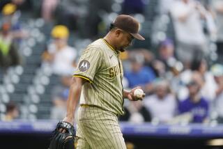 San Diego Padres relief pitcher Wandy Peralta reacts after throwing a wild pitch allowing the tying-run to score in the eighth inning of a baseball game against the Colorado Rockies, Thursday, April 25, 2024, in Denver. (AP Photo/David Zalubowski)