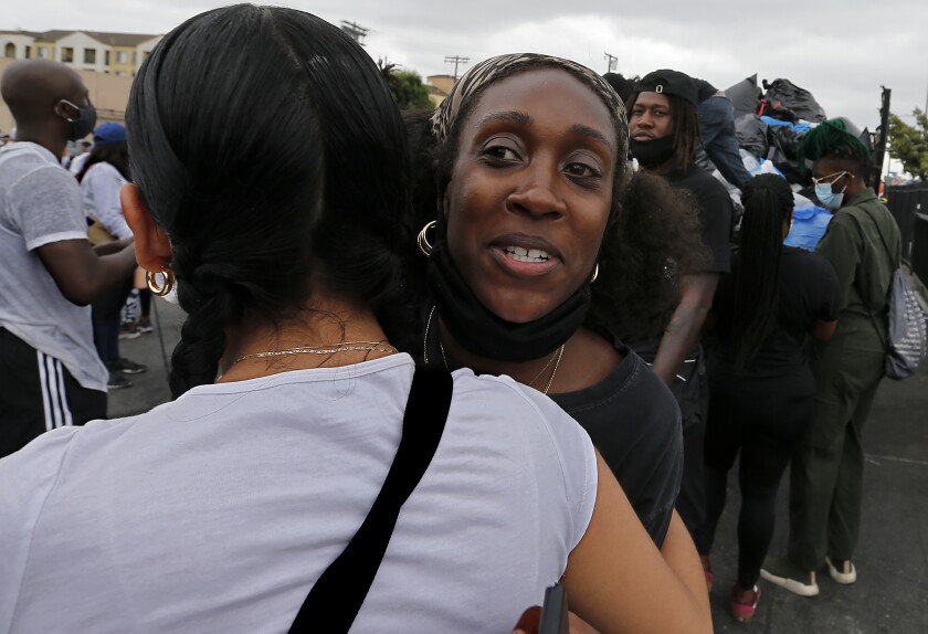 Diamond Jones gets a hug from a supporter on Friday.