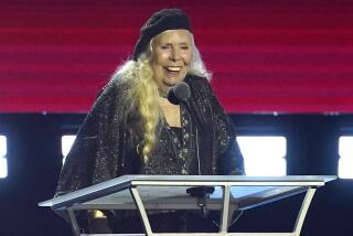 Joni Mitchell accepts the Person of the Year award at the 31st annual MusiCares benefit gala on Friday, April 1, 2022, at the MGM Grand Conference Center in Las Vegas. (AP Photo/Chris Pizzello)