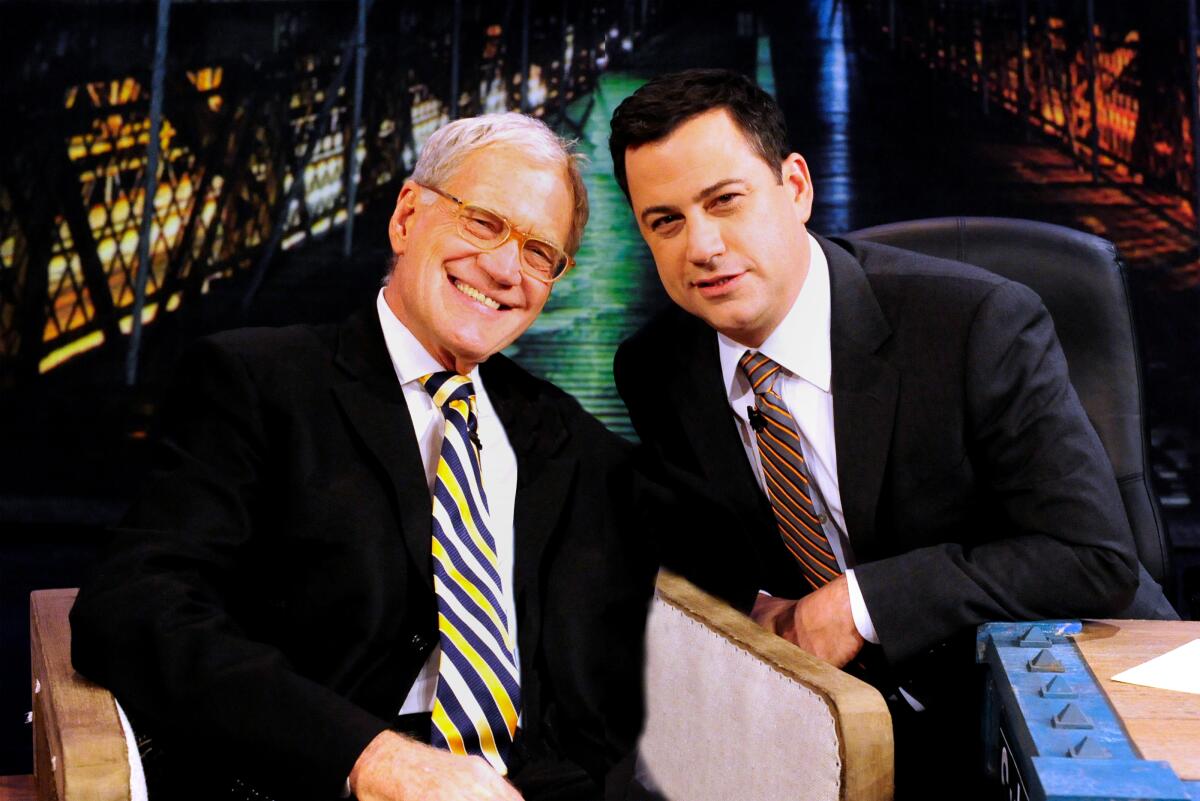 David Letterman sits in an armchair and leans in toward Jimmy Kimmel behind a desk on "Jimmy Kimmel Live."