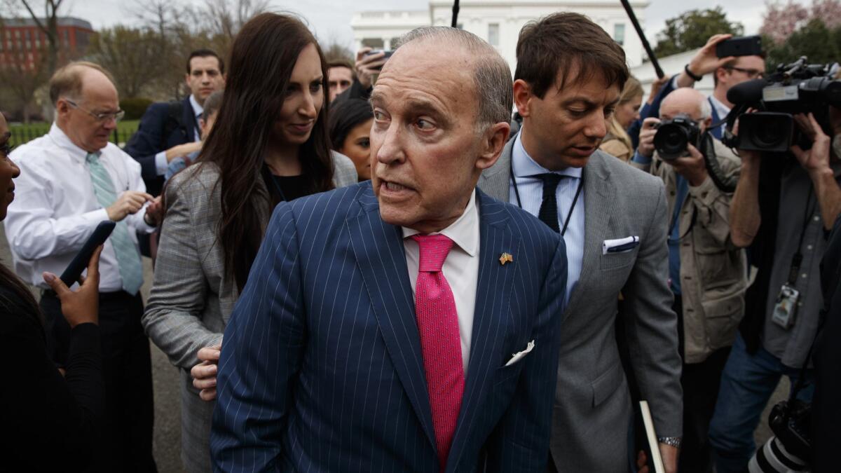 White House chief economic advisor Larry Kudlow talks with reporters outside the White House on Wednesday.