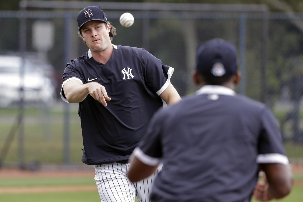 Yankees pitcher Gerrit Cole throws to first base a spring training practice drill.