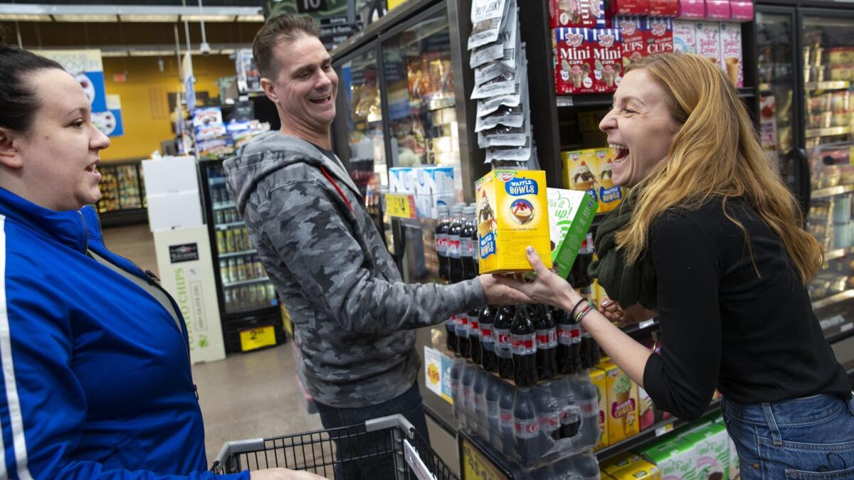 Milk Bar's, from left, Anna McGorman, director of culinary operations, Scotty Blenkarn, head of the R&D Lab, and Christina Tosi, the bakery's creator, shop for ingredients at Ralphs market.