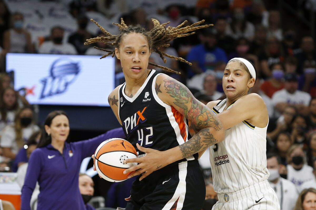 FILE - Phoenix Mercury center Brittney Griner (42) drives past Chicago Sky forward Candace Parker (3) during the first half of Game 1 of the WNBA basketball Finals, Sunday, Oct. 10, 2021, in Phoenix. Brittney Griner's return to the WNBA this summer after being traded in a dramatic prisoner swap in December with Russia has collided with free agency, creating potential travel complications for the league out of safety concerns for her.( AP Photo/Ralph Freso, File)