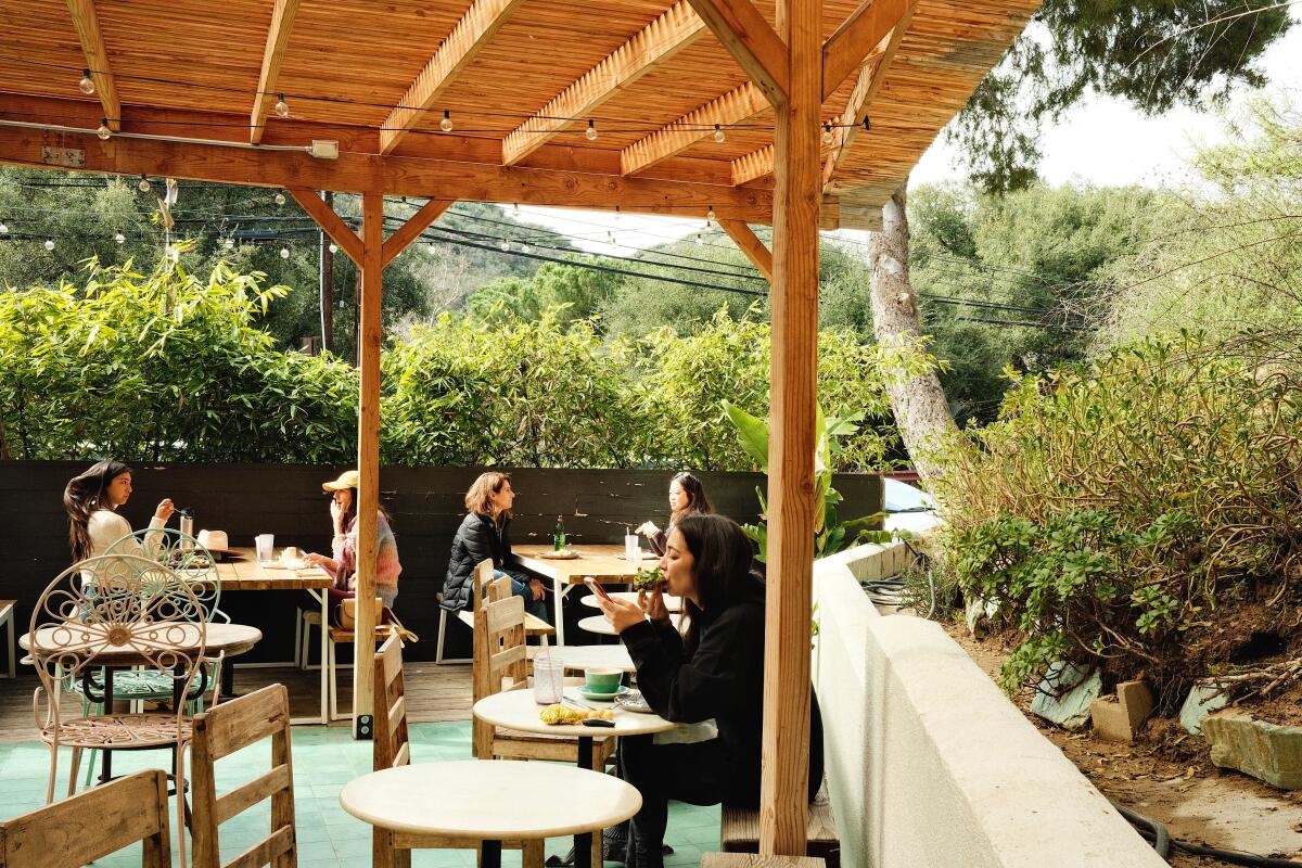 Guests dine on the patio of Topanga Living Cafe, which is tucked into a canyon hillside