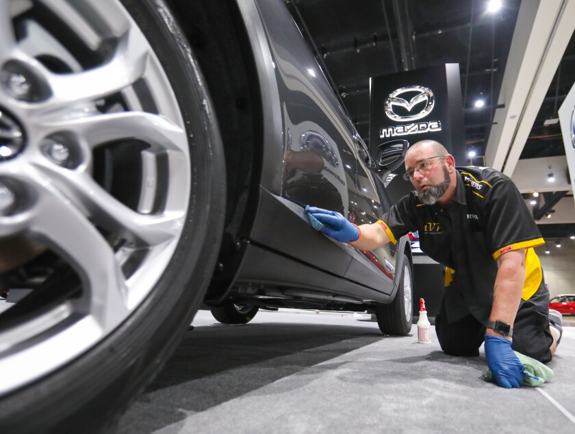 Tony Fronius details a 2020 Mazda CX-3 compact sport utility vehicle in the Mazda display space at the San Diego Convention Center in advance of the San Diego International Auto Show that opens on New Year's Day, 2020, and runs through Sunday.