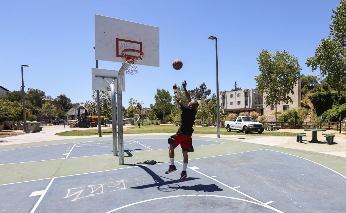  A man plays basketball at the Wightman Street Neighborhood Park in City Heights Tuesday