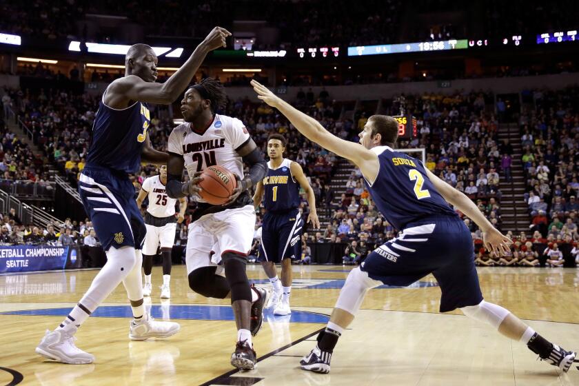Louisville forward Montrezl Harrell (24) tries to drive to the basket between UC Irvine center Mamadou Ndiaye and forward Travis Souza in the first half of their NCAA tournament game.