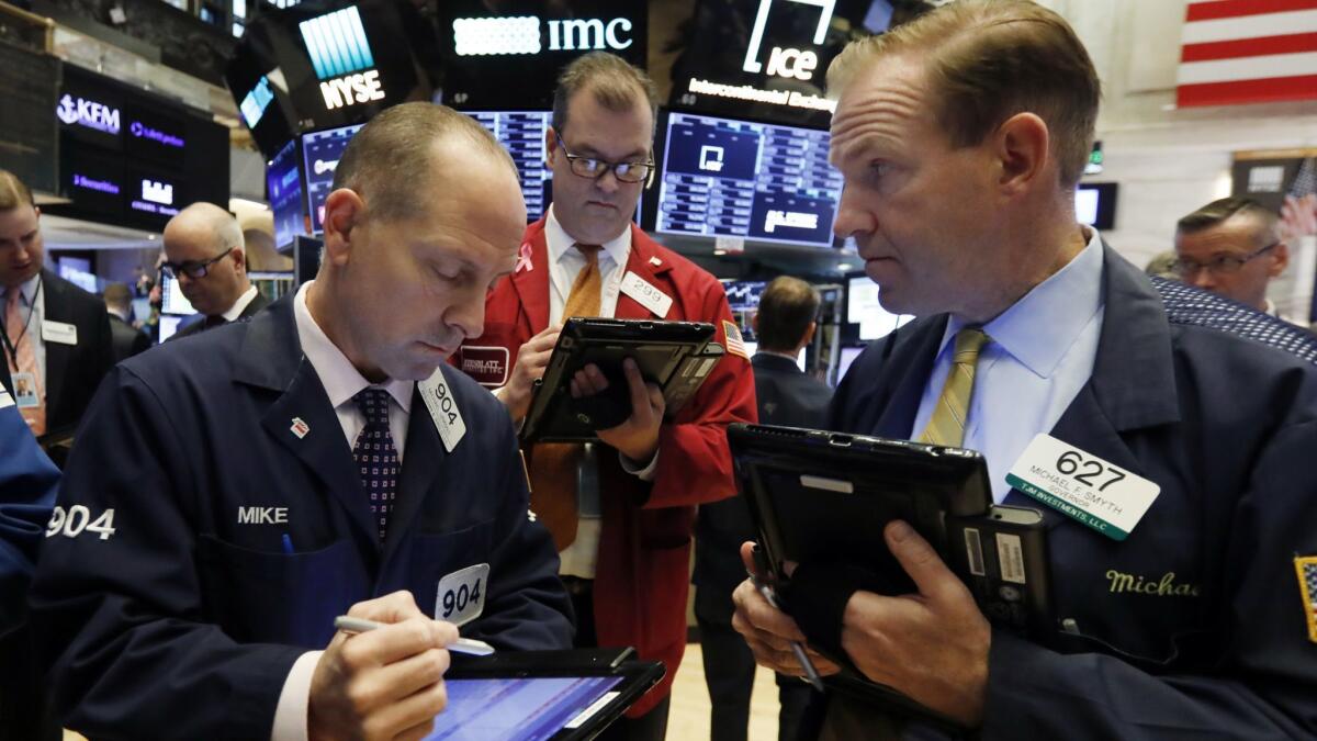 Traders work on the floor of the New York Stock Exchange.