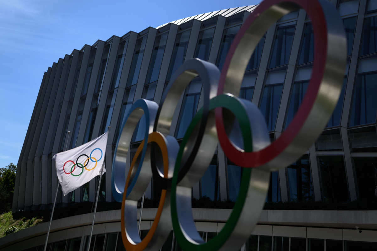The Olympic rings and flag outside the headquarters of the International Olympic Committee in Lausanne, Switzerland