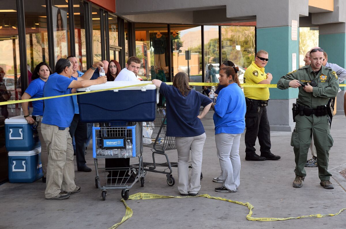Las Vegas police and Wal-Mart employees near the store in which two right-wing extremists died.