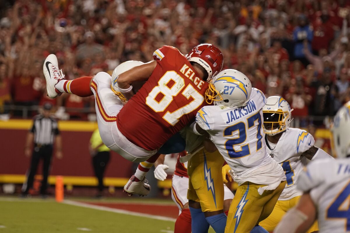 Kansas City Chiefs tight end Travis Kelce is slammed to the turf by Chargers safety Derwin James Jr.