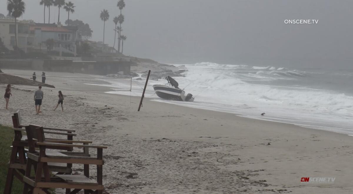A family plays volleyball Nov. 5 near where a possible smuggling boat was abandoned at Marine Street Beach in La Jolla.