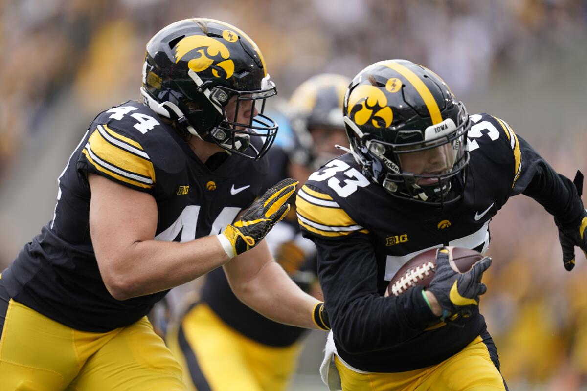 Iowa defensive back Riley Moss returns an interception 30 yards for a touchdown during the first quarter.