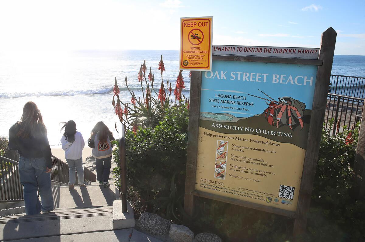 A sign warning beachgoers at Oak Street after a reported sewage spill in Laguna Beach.