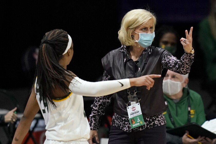 Baylor head coach Kim Mulkey, right, signals a play while talking with guard Sarah Andrews (24) during the first half of an NCAA college basketball game against TCU in the quarterfinal round of the Big 12 Conference tournament in Kansas City, Mo., Friday, March 12, 2021. (AP Photo/Orlin Wagner)