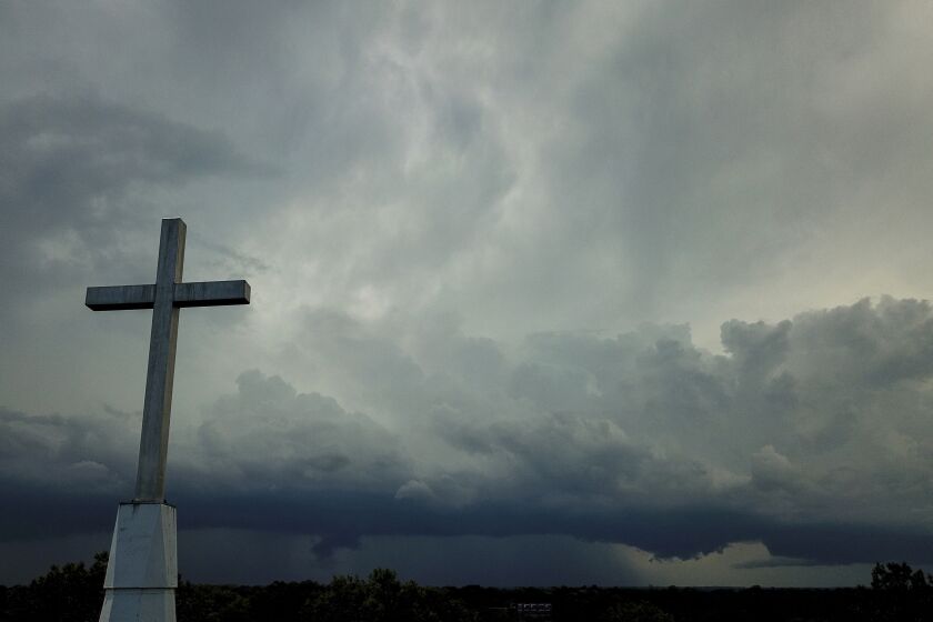 FILE - Storm clouds approach a church in Mequon, Wis., on Sunday, Aug. 2, 2020. A new Pew Research Center report published Thursday, Nov. 17, 2022 explores how religion in the U.S. intersects with views on the environment and climate change. (AP Photo/Morry Gash)