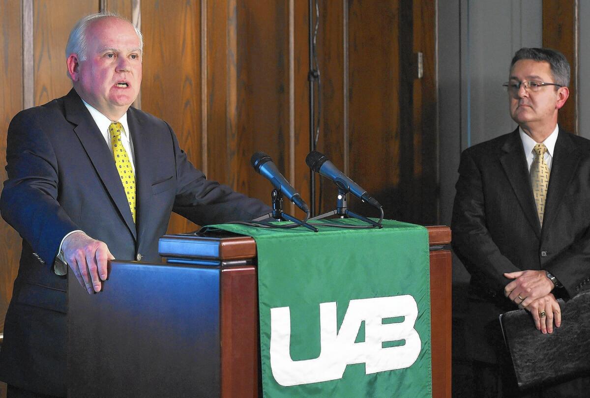 "Football is simply not sustainable," says University of Alabama at Birmingham President Ray Watts, left.