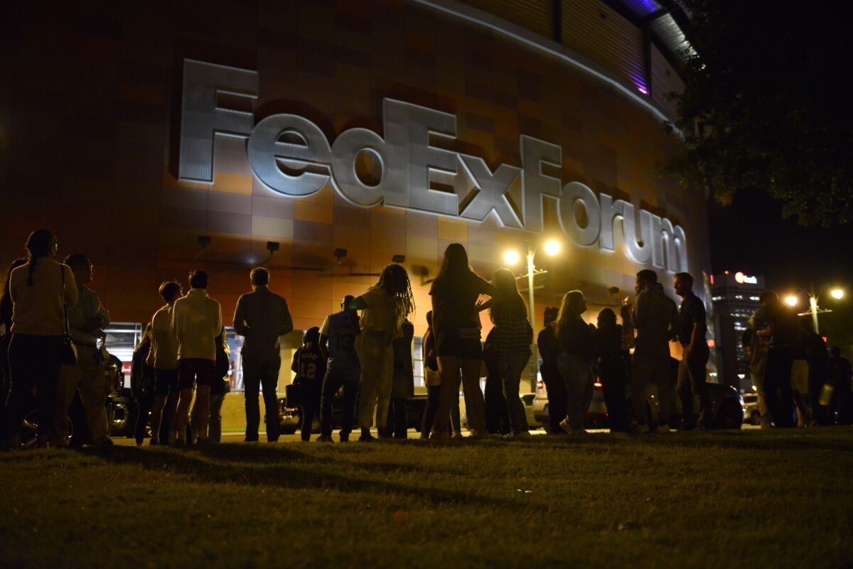 Fans wait outside FedExForum after a fire alarm went off during an NBA preseason basketball game between the Milwaukee Bucks and the Memphis Grizzlies Tuesday, Oct. 5, 2021, in Memphis, Tenn. (AP Photo/Brandon Dill)