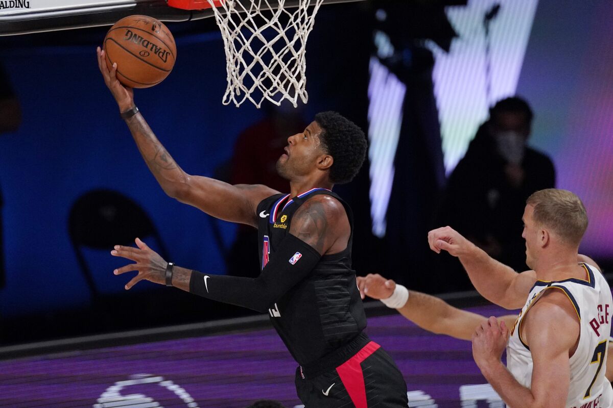 Clippers forward Paul George attempts a layup against the Nuggets during Game 1 of their playoff series on Thursday.