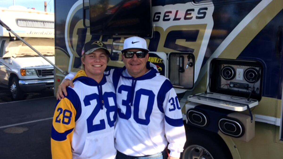 "I love watching the Rams," says Neal Dawson, shown with his son, Luke, in front of the family's RV before Sunday's game.