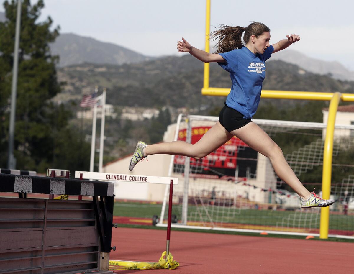 GCC steeplechase athlete Phoebe Forsyth, a Burbank High School graduate, clears a barrier while running a timed lap at track practice at Glendale Community College on Tuesday, January 29, 2020.