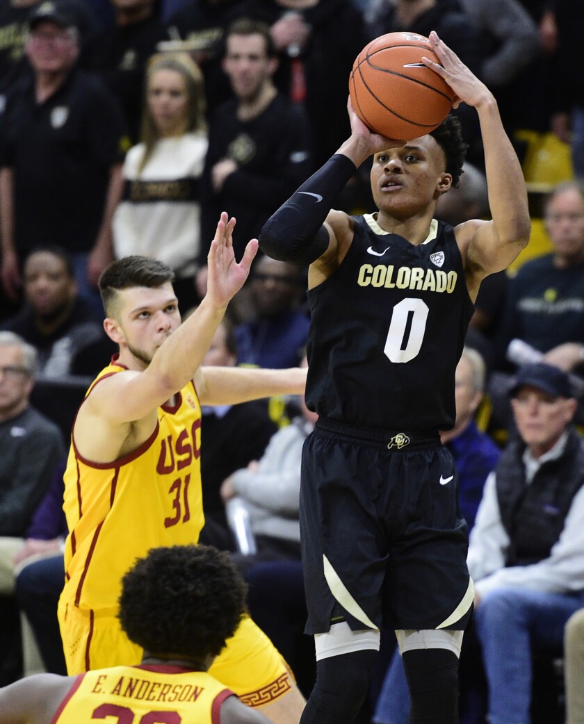 Colorado guard Shane Gatling puts up a 3-point shot in front of USC forward Nick Rakocevic during the second half of a game Feb. 20 at CU Events Center.