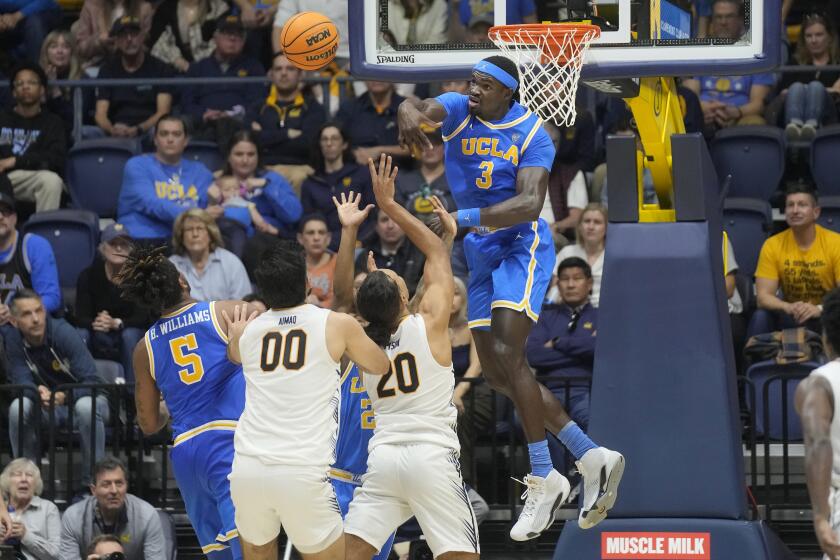 UCLA forward Adem Bona jumps and blocks a shot attempt by California guard Jaylon Tyson 