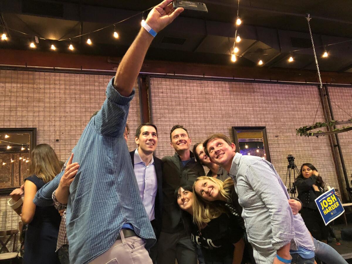 Democrat Josh Harder poses with supporters in Modesto on Nov. 6.